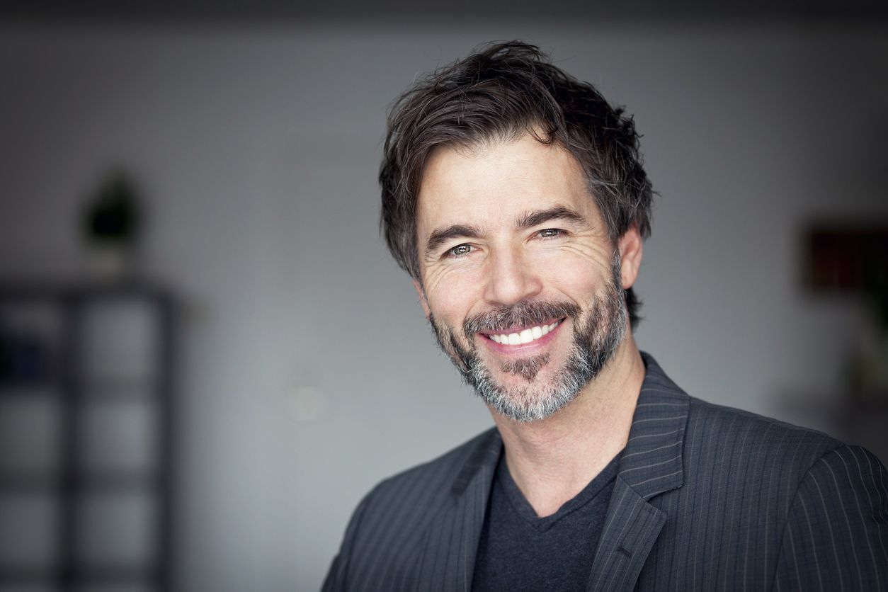 Close Up Of A Mature Man Smiling At The Camera